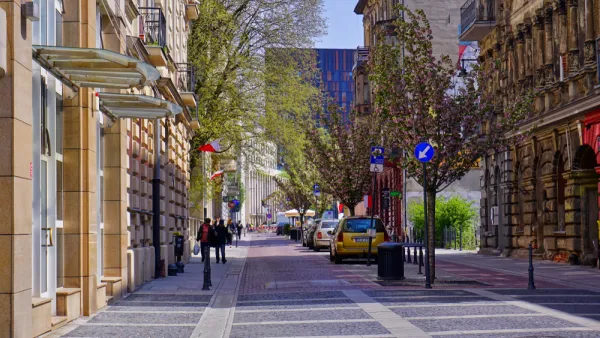 Woonerf street with no curbs and trees in Lodz, Poland